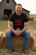 Country guy sitting on hay bales wearing I Do She Don't graphic t-shirt